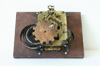 Clock, Parts, MOUNTED CLOCKWORKS W/GEARS, BROWN RECTANGULAR WOOD BASE, LARGE WOODEN GEAR, UNWOUND, AGED, METAL, BRASS