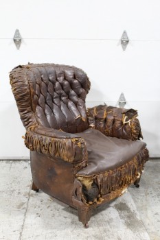 Chair, Armchair, BUTTON TUFTED, PLEATED TRIM, SMALL WHEELS, AGED RIPPED & DISTRESSED W/EXPOSED STUFFING, LEATHER, BROWN